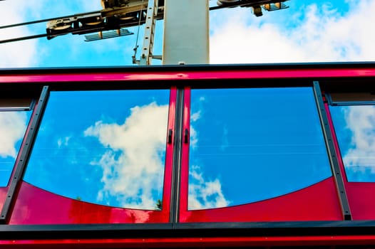 Cable car and the reflection of the sky in the glass