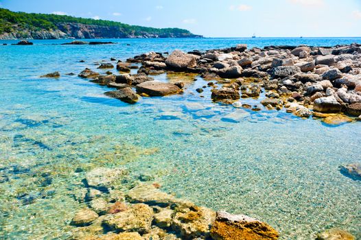 rocky bottom of the sea and a ship on the horizon