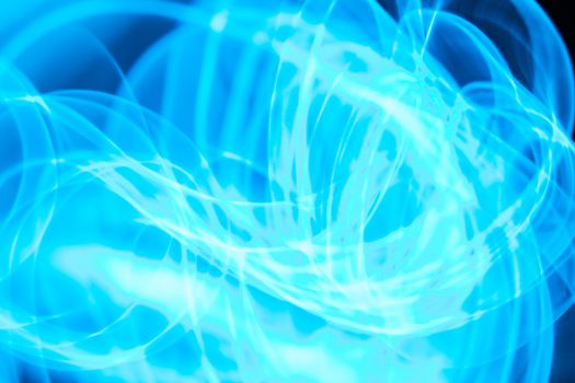 Curved bluish lines. Abstract wave forms of light in long exposure.