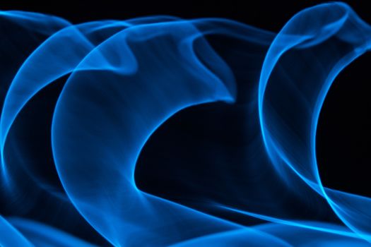 Curved bluish lines. Abstract wave forms of light in long exposure.