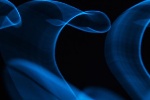 Curved bluish lines. Abstract wave forms of light in long exposure.