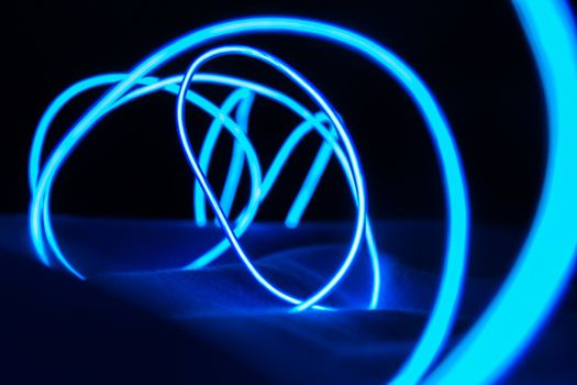 Curved bluish lines. Abstract wave forms of light in long exposure.