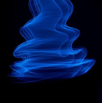 Curved bluish lines. Abstract wave forms of light in long exposure.