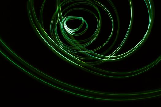 Curved green lines. Abstract wave forms of light in long exposure.