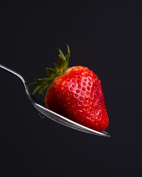 A Silver Spoon Sulverware Utensil Holds Fresh Raw Food Red Strawberry Sweet Snack
