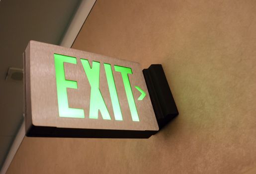 Lighted Wall Mounted Exit Sign Shows People Way Out Public Building