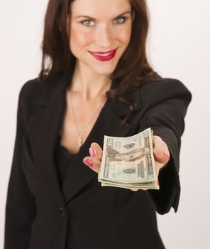 Brunette wokman in a business suit holds out some cash to the viewer