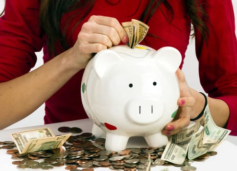 Woman saving money the old fashioned way in Piggy Bank