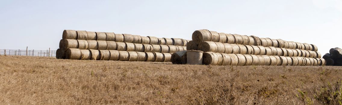 View of a stack of hay bales on the countryside.