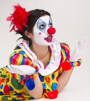 Clown; Circus; Face Paint; Female; Human Role; Behavior; Ecstatic; Cheerful; Studio Shot; Looking At Camera; Entertainment; Red; White; Performer; Isolated; Stage Costume; Birthday; Carnival; Theatrical Performance; People; Multi Colored; Humor; Surprise; Whiteface Mountain; Wig; Wrinkled; Comedy Mask; Facial Expression; Fame; Women; Portrait; Dressing Up; Characters; Joker; Actor; Joy; Performance; Confusion; Make-up; One Person; Caucasian; Beauty; Fun; Smiling; Adult; Artist's Model; red hair; curly hair; vertical; 