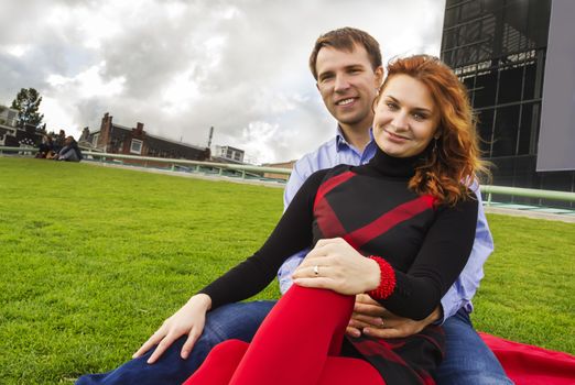 Outdoor happy couple in love posing in Museum Plein, autumn Amsterdam background