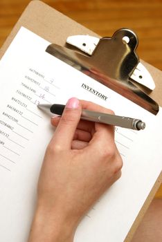 A young woman does an inventory check of the company supplies.