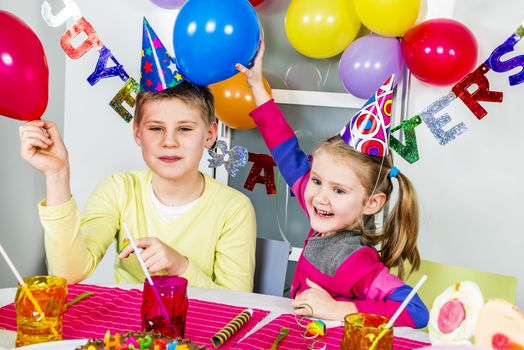 Happy little children are having fun in a birthday party 