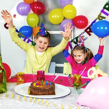 Happy little children are having fun in a birthday party 