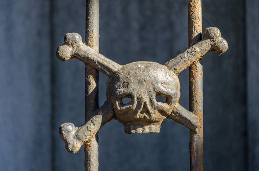 Iron skull and crossbones decorating a tomb in Recoleta cemetery in Buenos Aires, Argentina