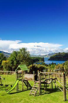 Vertical view of a playground in a natural setting with Neusa lake in the background in Cundinamarca, Colombia