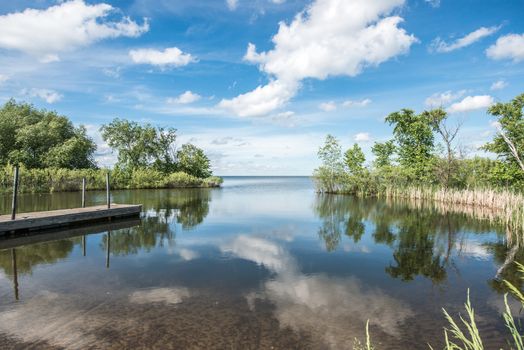 Beautiful landscape of quiet lake and shore during the summer