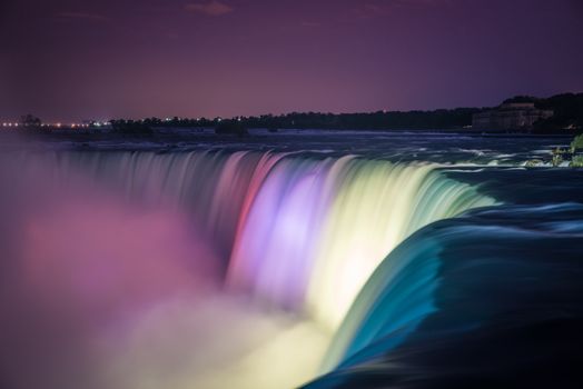 Niagara Falls at night illuminated by colored lights