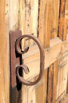 Old Rusty Handle on a Wooden Church Door