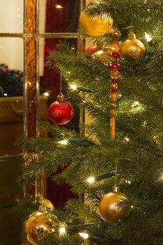 Decorated christmas tree and stained glass window - vertical