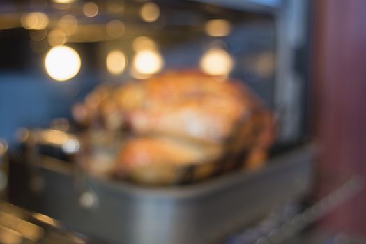 Thanksgiving Turkey in Roasting Pan in Oven Blurred Bokeh Defocused Background