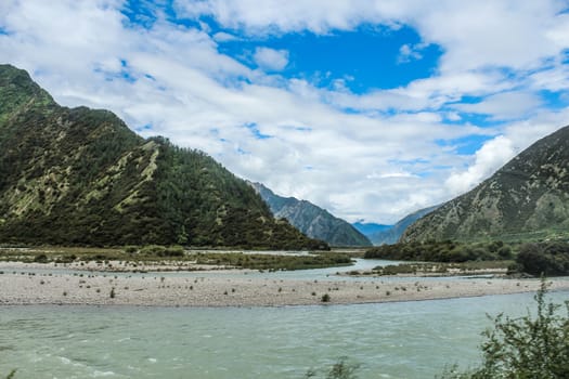 Beautiful landscape with high altitude lake cloud and mountains during a sunny day