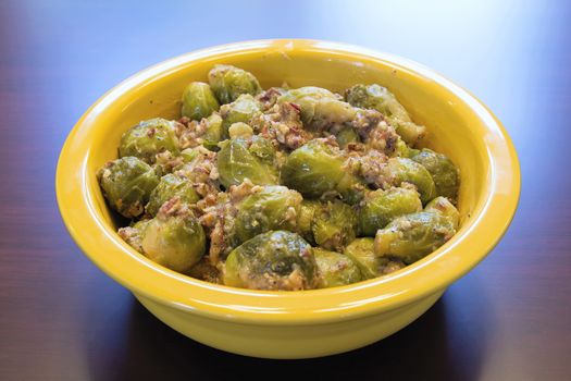 Brussel Sprouts Cooked with Pancetta Olive Oil and Onions in Yellow Bowl