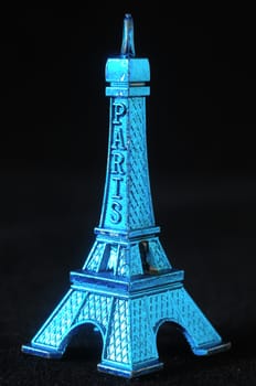 Blue Tour Eiffel Statuette on a Black Background