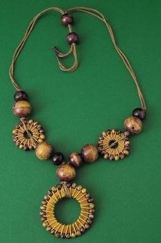 Handmade Wood Collar Necklace on a Colored Background