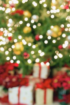 Christmas Tree Decoration with Ornaments Lights Poinsettia and Presents Bokeh Blurred Defocused Background