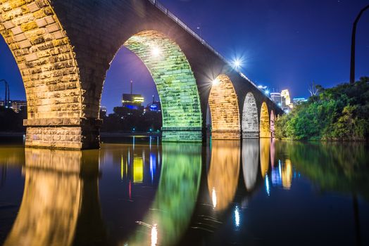 Night scenic view of stone arch bridge with vibrant colors in Minneapolis