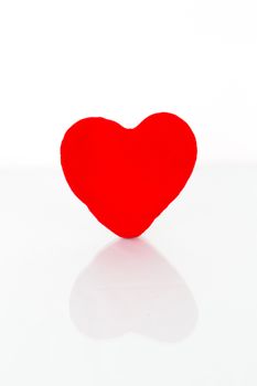 Red heart with reflection on a white background.