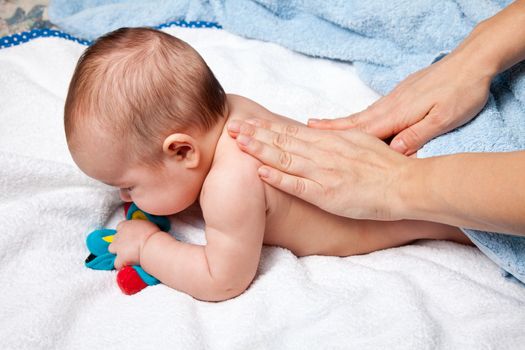 Masseuse massaging 5 months infant