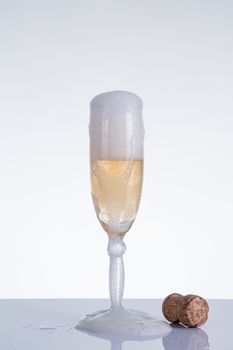 Elegant champagne glass and cork, New Year theme, studio shot on grey background 