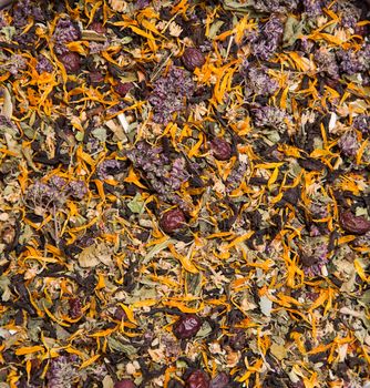 Texture of herbal tea with flowers and berries 