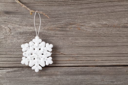 white christmas snowflake on wooden background