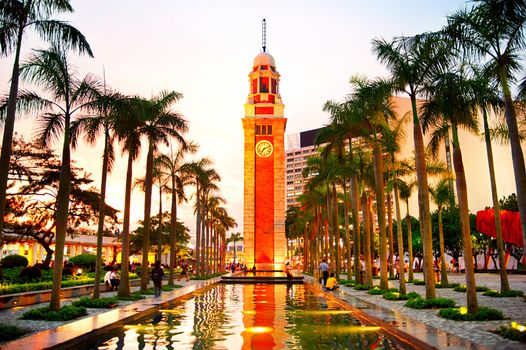 Hong Kong S.A.R. - May 16, 2013: People at Hong Kong Clock Tower. The landmark 44 meter tower is a remnant of the original Kowloon Station on the Kowloon-Canton Railway.