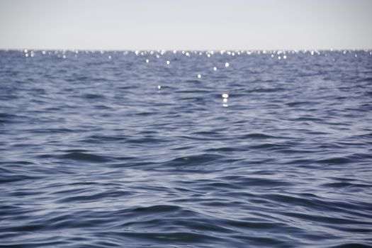 Blue ocean surface with light wave movement