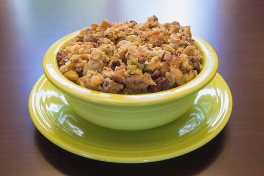 Thanksgiving Day Turkey Stuffing with Corn Bread Celery Cranberry in Green Bowl on Wood Table