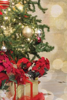 Christmas Tree Decoration with Bokeh Lights Sparkles Ornaments Ribbons Poinsettia and Presents Under the Tree