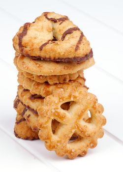 Stack of Various Butter Cookies with Chocolate and Sugar Glaze isolated on White Plank background