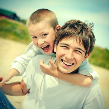 Vintage photo of Happy Teenager and Kid outdoor