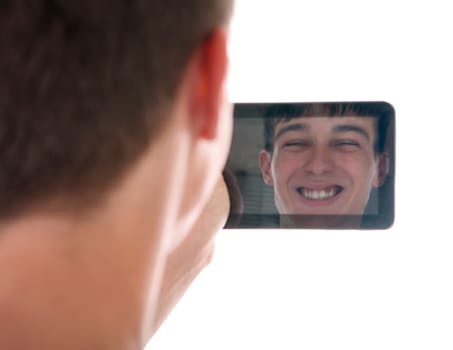 Reflection of Young Man Face in Display of Tablet Computer Isolated on the White Background