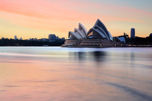 Sydney, Australia - November 28, 2013; Sydney Opera House and Sydney Harbour and foreshore at sunrise, before most harbour traffic stirs the waters.  Long exposure.