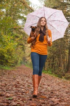 Young teenage girl is having a nice time in the cold november