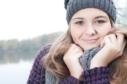 Young teenage girl is having a nice time in the cold november