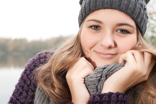 Young teenage girl is having a nice time in the cold november