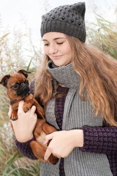 Young teenage girl is having a nice time in the cold november