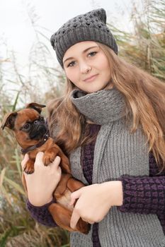 Young teenage girl is having a nice time in the cold november