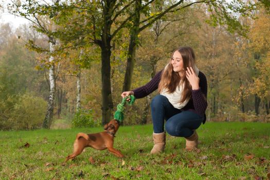 Young teenage girl is having a nice time in the cold november